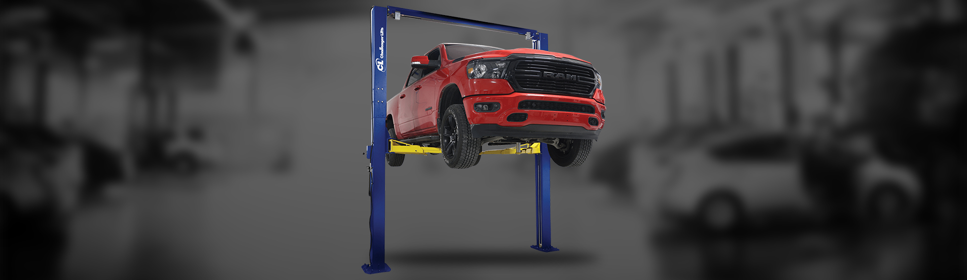 A car lifted off the ground by a Challenger Lifts LE12-3S